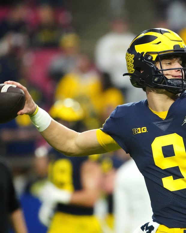 Michigan quarterback JJ McCarthy (9) throws a pass during the pregame before the Fiesta Bowl at State Farm Stadium in Glendale, Ariz., on Dec. 31, 2022.